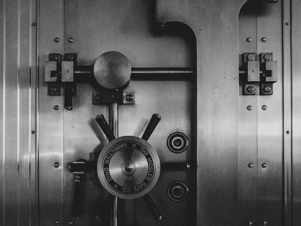 Close-up of a padlock securing a metal gate, illustrating access control and security readiness work.